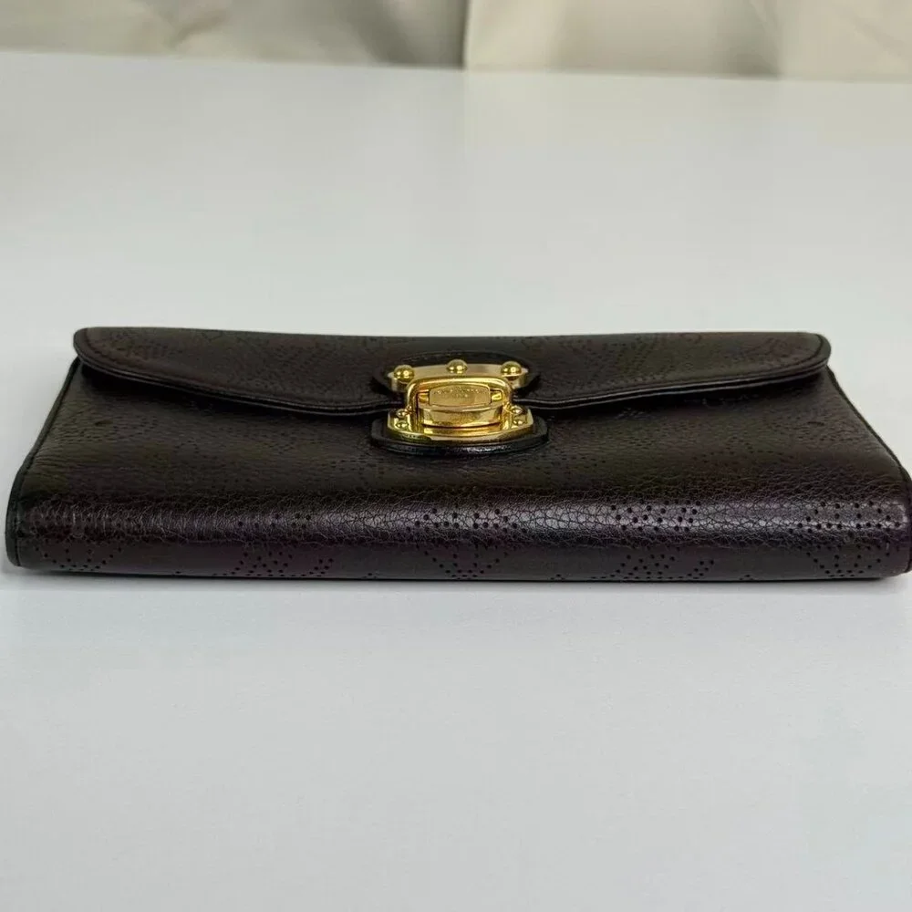 Louis Vuitton Black Monogram Canvas Wallet with Gold Hinge Detail Elegant Design